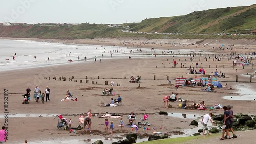 Holiday Makers On Beach; Sandsend Beach; Sandsend, North Yorkshire, England photo