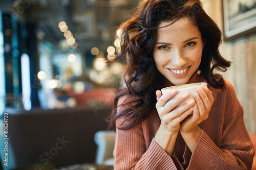 woman drinking coffee in a cafe