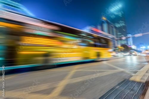 Bus speeding through night street in the city.