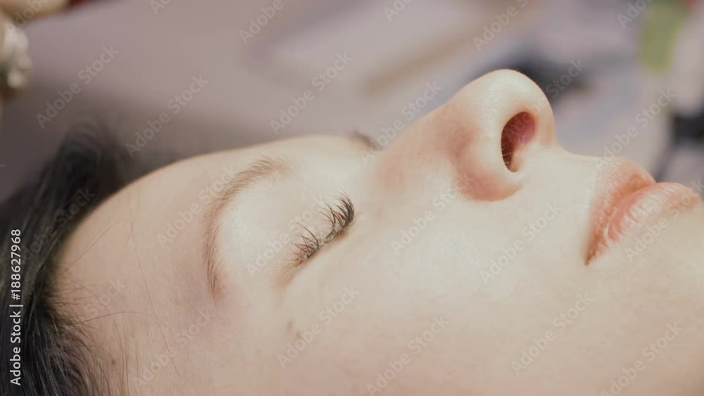 Woman's false eyelashes covered with special cream for their removing Woman's false eyelashes covered with special cream for their removing