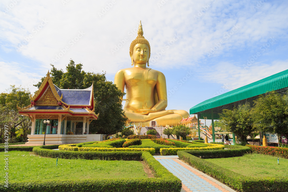 The large golden Buddha statue at Wat Muang against a clouds and blue sky. The large golden Buddha statue at Wat Muang against a clouds and blue sky.