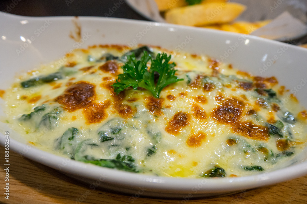 Close up spinach lasagna in white plate - Italian food style Close up spinach lasagna in white plate - Italian food style