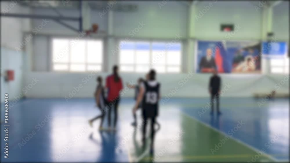 children playing the basketball match blurred background. basketball sports indoors kids game
