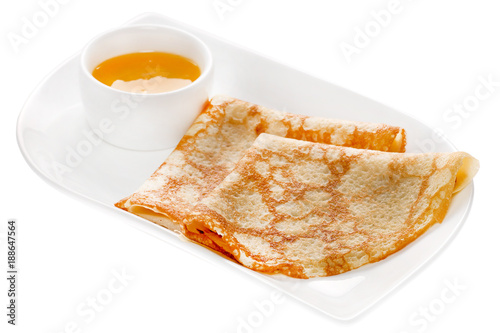 Fried pancakes on plate with sauce isolated