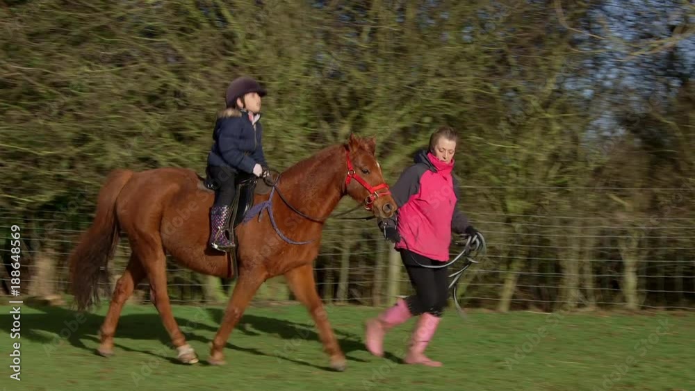 Teaching Girl To Ride Pony; Learning To Ride A Pony; Catwick, East Yorkshire Teaching Girl To Ride Pony; Learning To Ride A Pony; Catwick, East Yorkshire