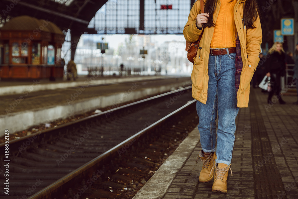 woman walk by railway station - obrazy, fototapety, plakaty 