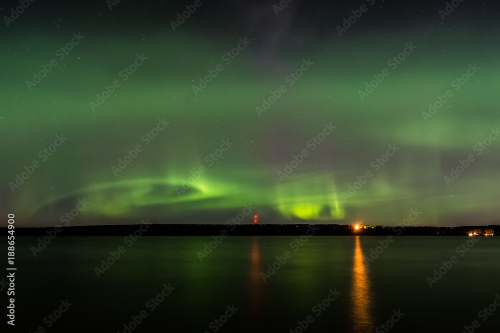 Aurora borealis (polar lights) by the lake in Southern Finland