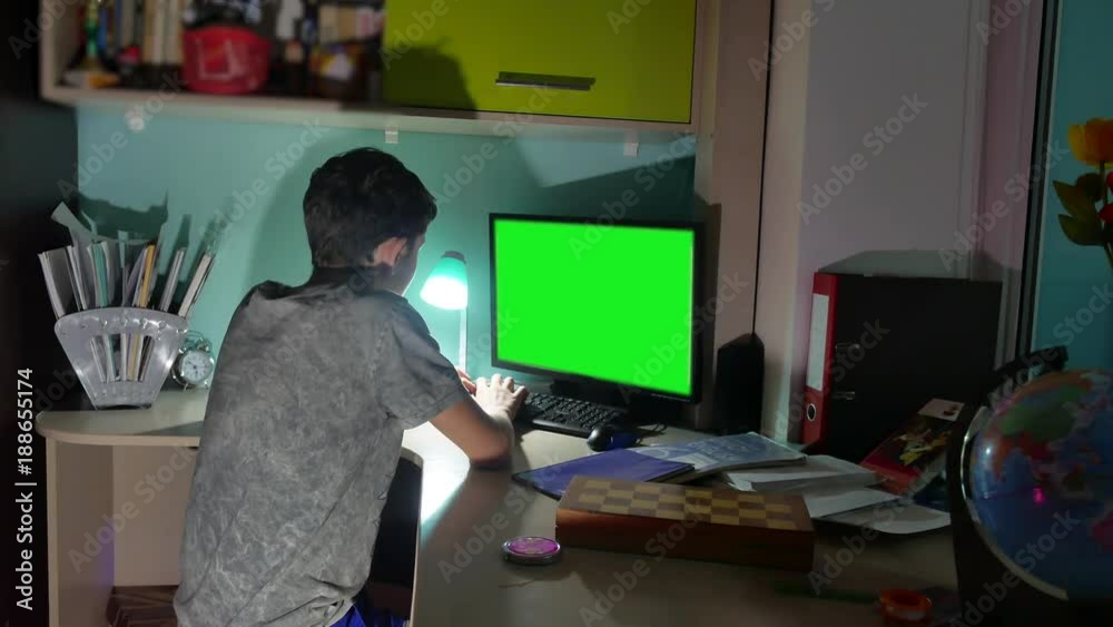 Green Key indoors Teenage Boy Playing Computer Close-Up Hands Game Video Sitting Back. young student examinations man working on the computer at home at night indoor in the dark
