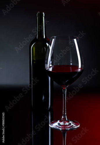 Glass and bottle of red wine.
