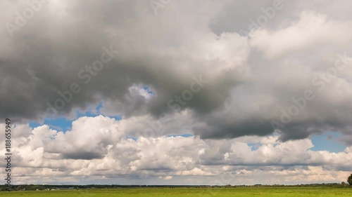 Time lapse of a Dutch meadow in Vreeland with moving gray and white clouds. photo