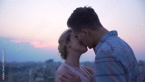 Guy gently and heatedly kissing his girlfriend, passionately hugging her, desire