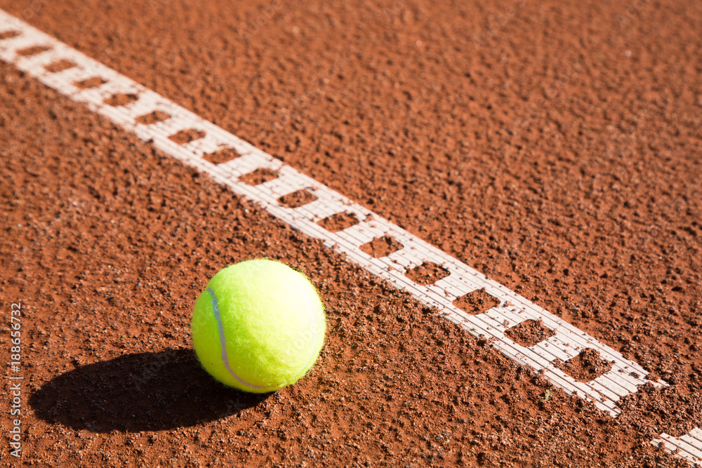 tennis ball with line on a sand court