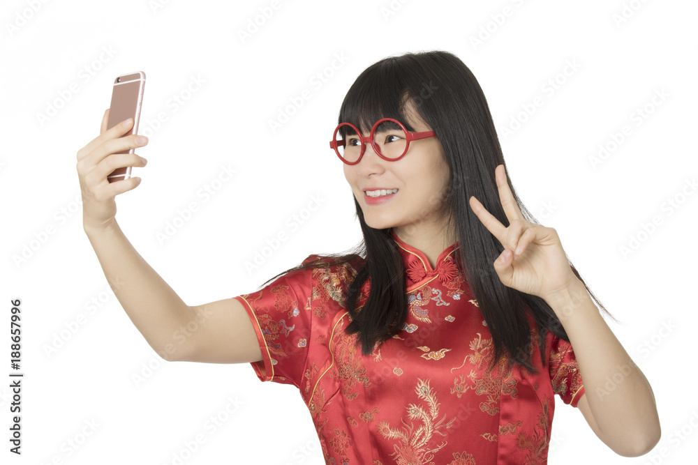 Asian woman using a cell phone to take a selfie isolated on white background