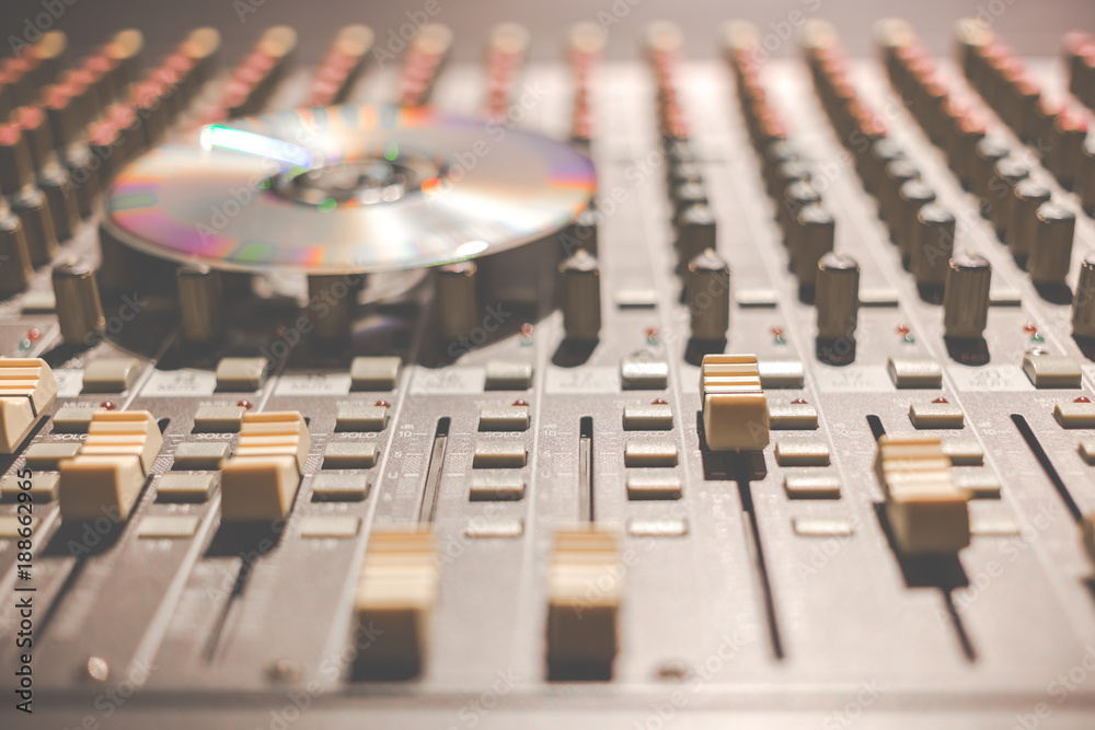 compact disc on sound mixer, focus on knob compact disc on sound mixer, focus on knob