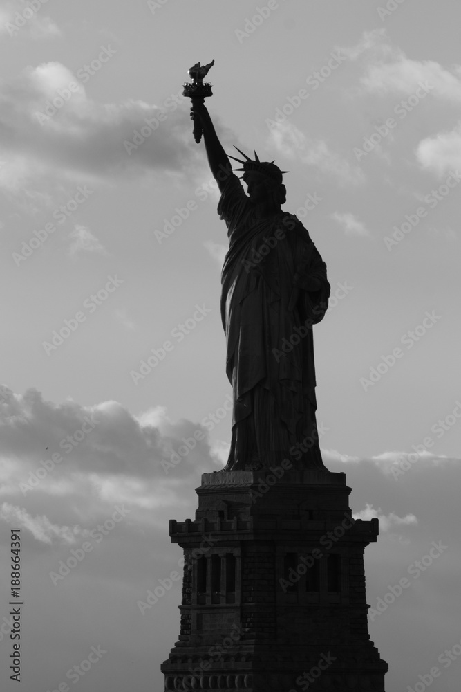 Silhouette of statue of Liberty in New York City at sunset - black and white