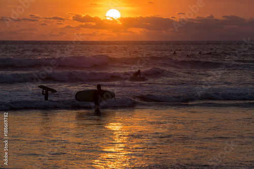 Fototapeta Naklejka Na Ścianę i Meble -  Surfing the waves of Indonesia beach