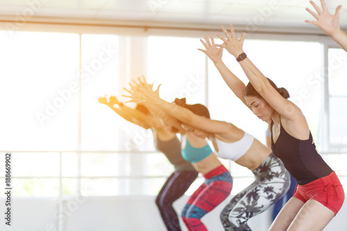 Women asian exercising in fitness studio yoga classes
