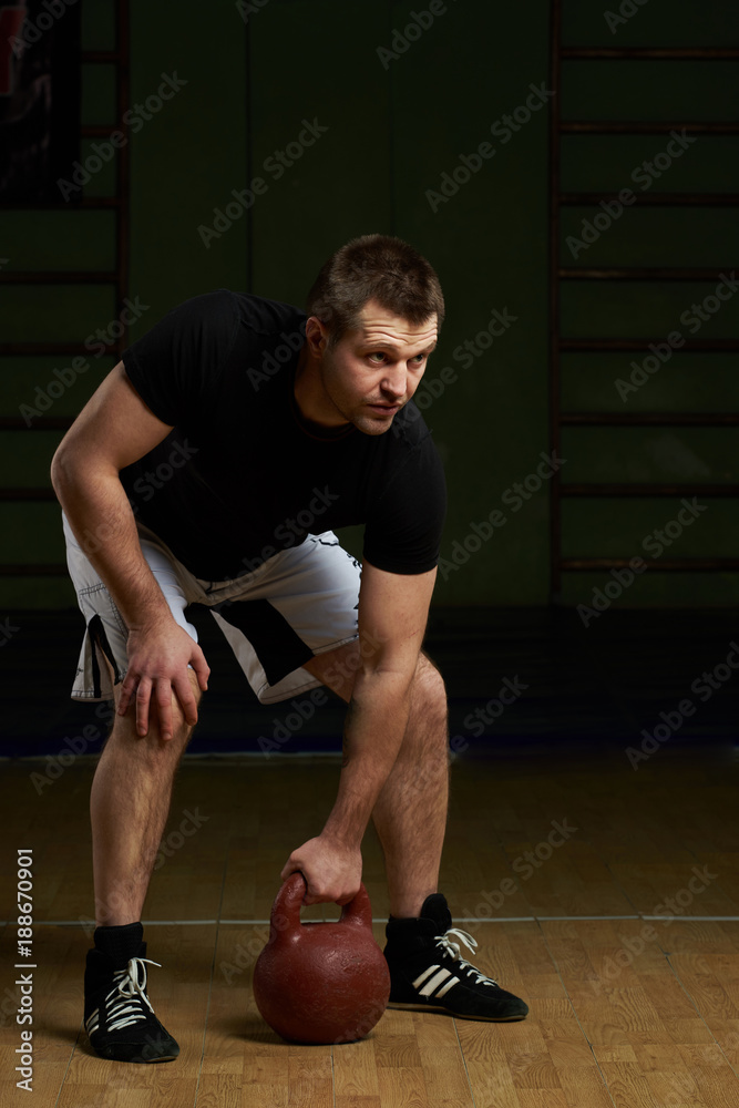 Naklejka premium Man trying lift weight