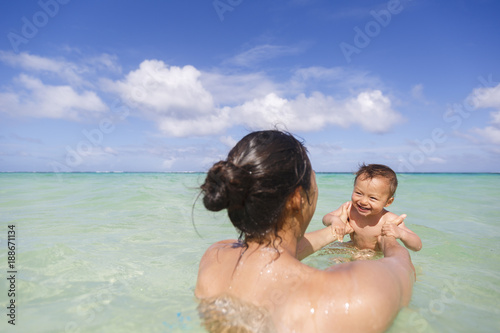 A mother with her son are swimming and playing in a sea © grigorylugovoy