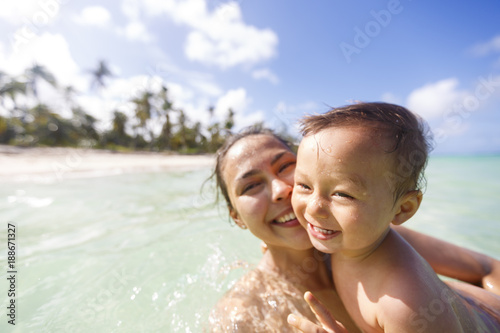 A mother with her son are swimming and playing in a sea © grigorylugovoy