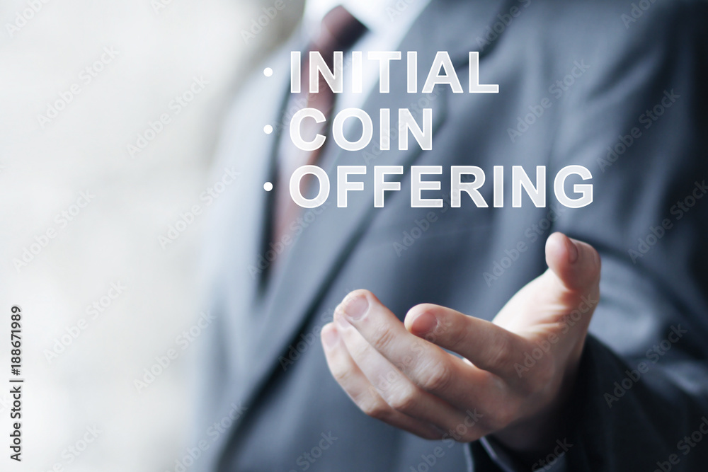 Businessman presses button ICO Initial Coin Offering on virtual digital electronic user interface. Businessman presses button ICO Initial Coin Offering on virtual digital electronic user interface.
