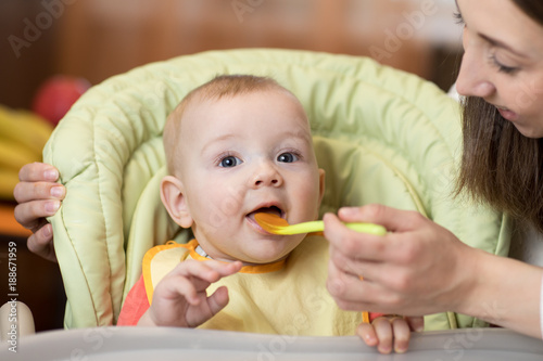 Mother feeding her baby wit...