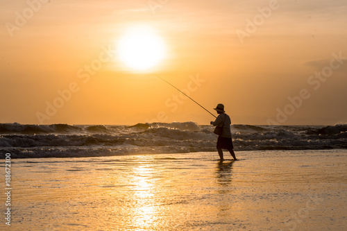 Man fishing in the evening at beach