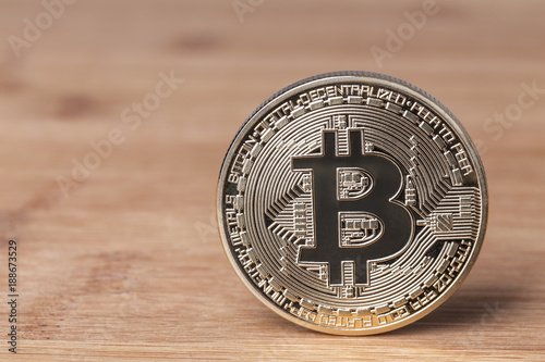 Bitcoin coin on a wooden background. Crypto currency.