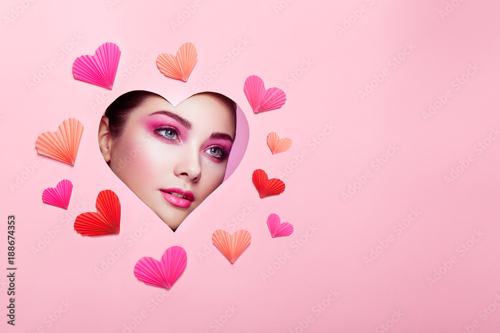 Conceptual photo of Valentine's day. Face of Girl with Festive Pink Makeup. Paper hearts on a pink background. Love symbols Valentines day Conceptual photo of Valentine's day. Face of Girl with Festive Pink Makeup. Paper hearts on a pink background. Love symbols Valentines day