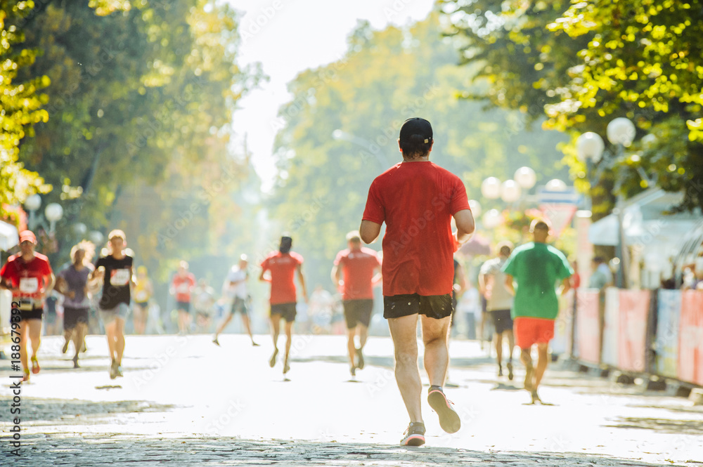 Fototapeta premium Athletes run in the park on the running marathon