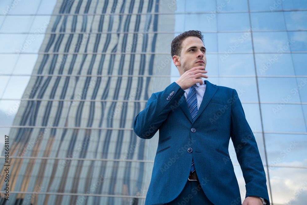 Young business man looking towards the future making a gesture of success. Young business man looking towards the future making a gesture of success.
