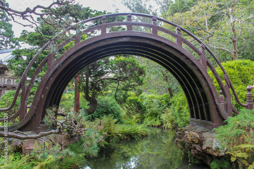 A Japanese arched metal bridge, over a stream in the Japanese tea gardens, San Francisco © SalBel
