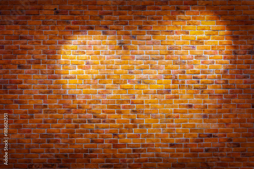 Vintage brick wall background with spotlights on the wall in heart shape