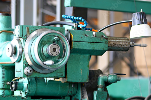 metalworking machining industry. finishing or grinding metal surface on grinder machine at factory