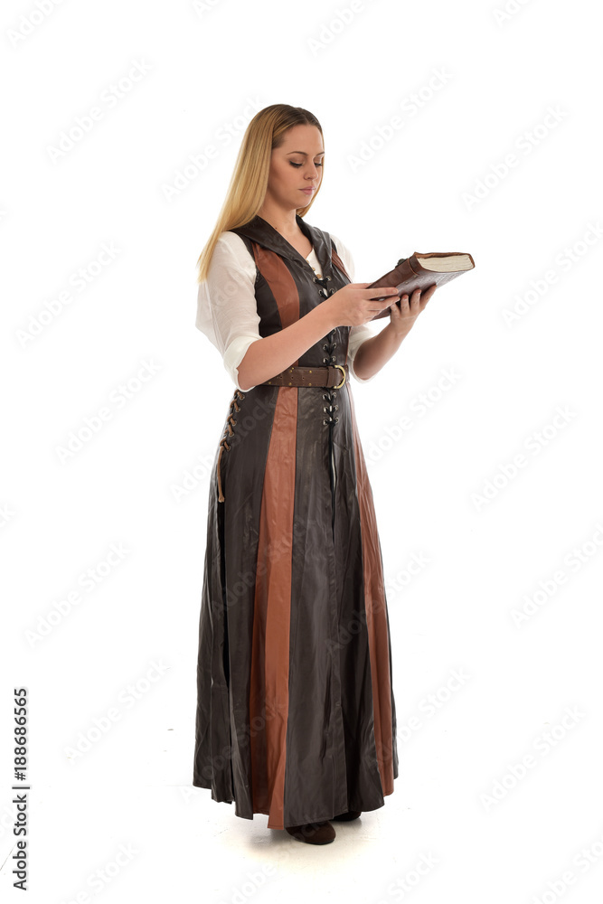 full length portrait of girl wearing brown fantasy costume, holding a book. standing pose on white studio background. full length portrait of girl wearing brown fantasy costume, holding a book. standing pose on white studio background.