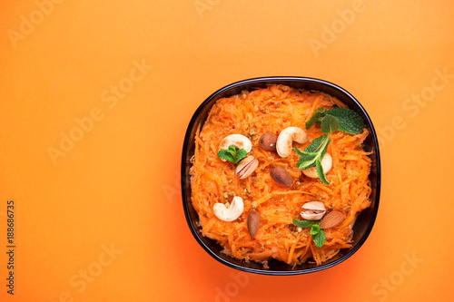 Indian carrot Gajar halwa. Copyspace, top view, flatlay. Color surge photo