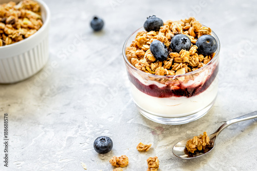 Healthy breakfast from yoghurt with muesli and berries on kitche