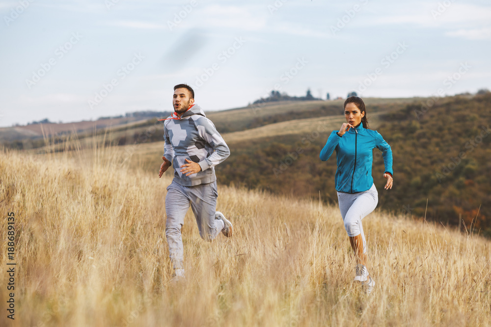 Young sport couple jogging in nature