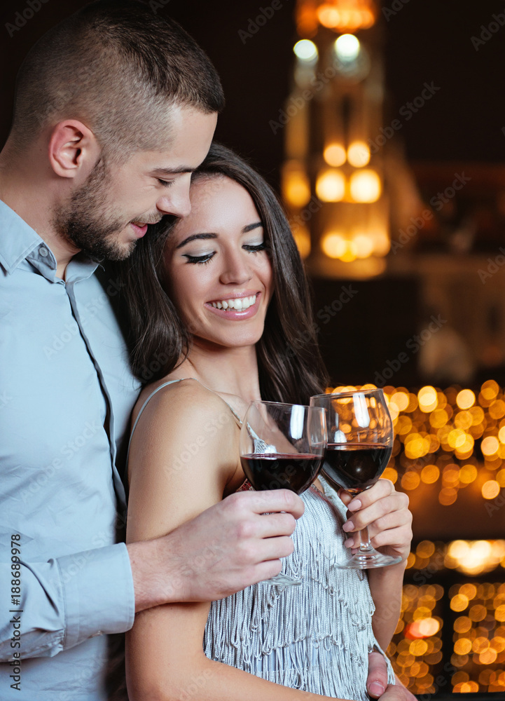 Couple in love, hugging and enjoying in red wine, celebrating Couple in love, hugging and enjoying in red wine, celebrating