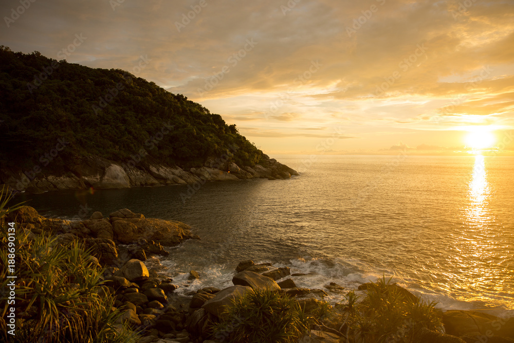 Beautiful sunrise cloudscape over ocean background. Sun rays beaming through picturesque clouds above sea Beautiful sunrise cloudscape over ocean background. Sun rays beaming through picturesque clouds above sea