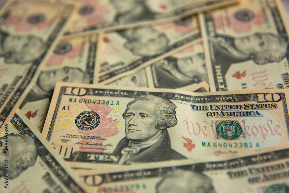 A Pile of Ten Dollar Bills as a Money Background A Pile of Ten Dollar Bills as a Money Background