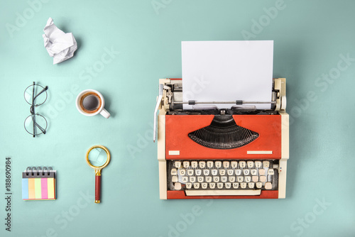 Red typewriter and fresh coffee (flat lay) photo