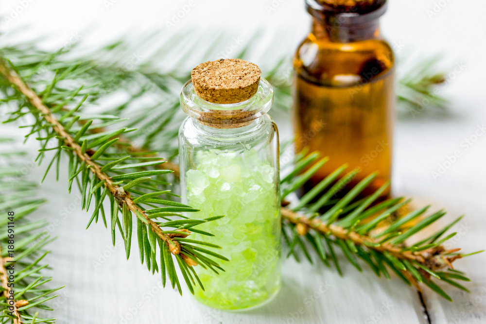 Bottles of essential oil and fir branches for aromatherapy and s Bottles of essential oil and fir branches for aromatherapy and s