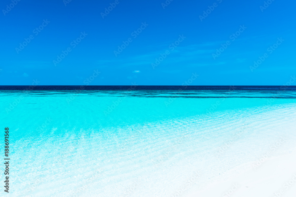 Obraz premium Turquoise lagoon of a tropical island. Turquoise lagoon of a tropical island in the ocean. White sand on the beach. Summer paradise for relaxation.