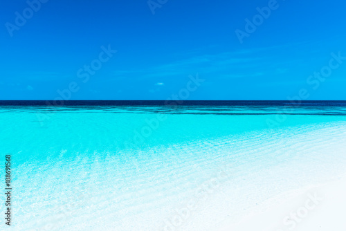 Turquoise lagoon of a tropical island. Turquoise lagoon of a tropical island in the ocean. White sand on the beach. Summer paradise for relaxation. © patma145