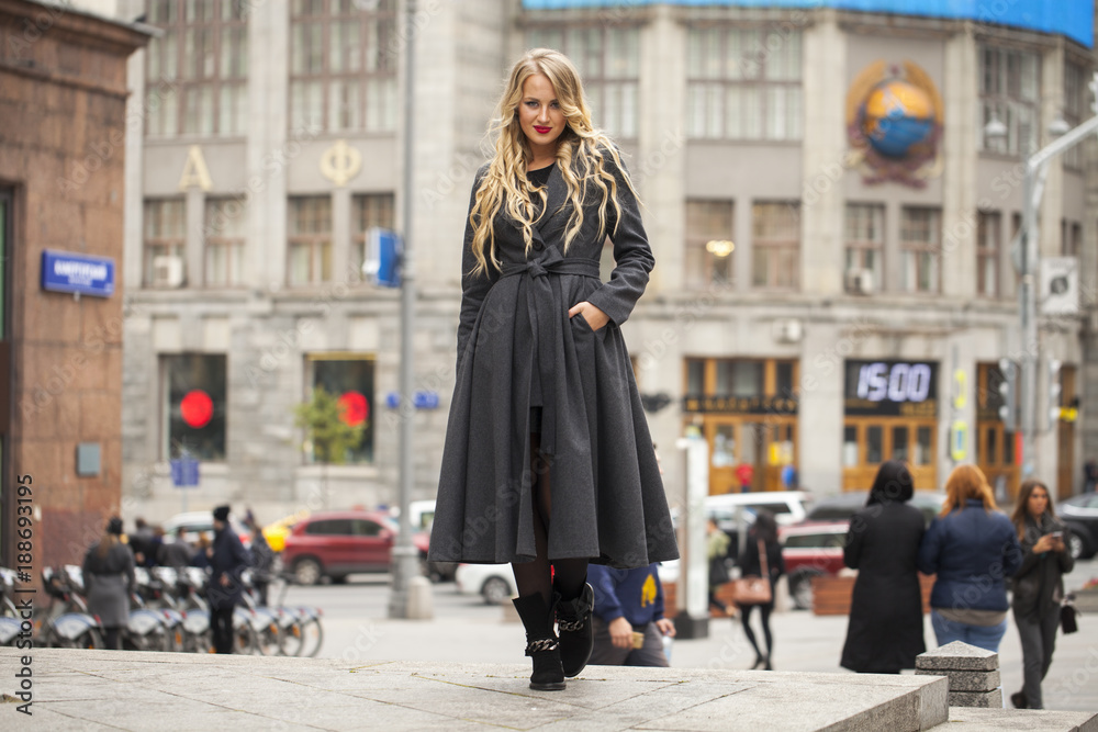 Portrait of a young beautiful woman in gray coat