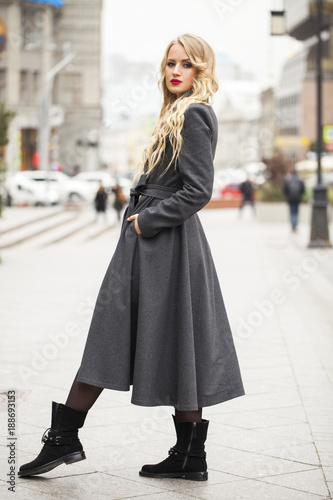 Portrait of a young beautiful woman in gray coat