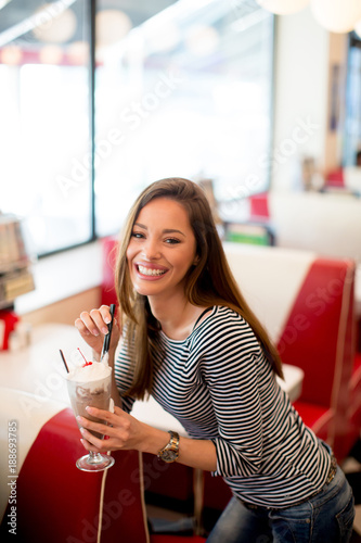 Woman drinks  milkshake at ...
