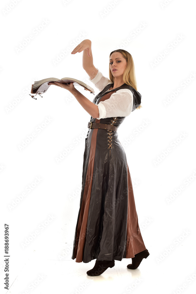 full length portrait of girl wearing brown fantasy costume, holding a book. standing pose on white studio background. full length portrait of girl wearing brown fantasy costume, holding a book. standing pose on white studio background.