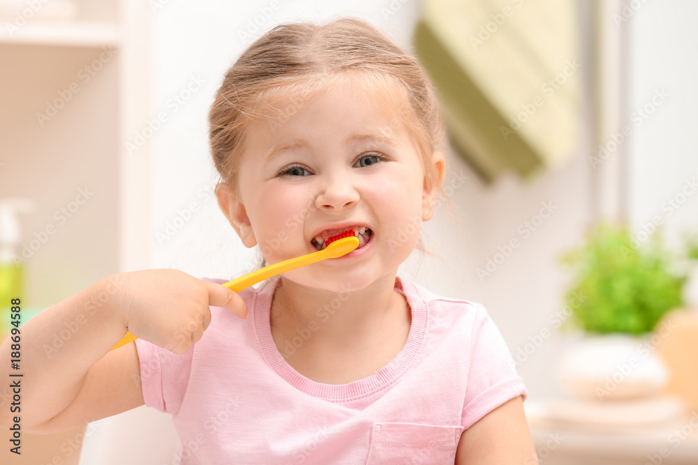 Cute little girl brushing teeth in bathroom Cute little girl brushing teeth in bathroom